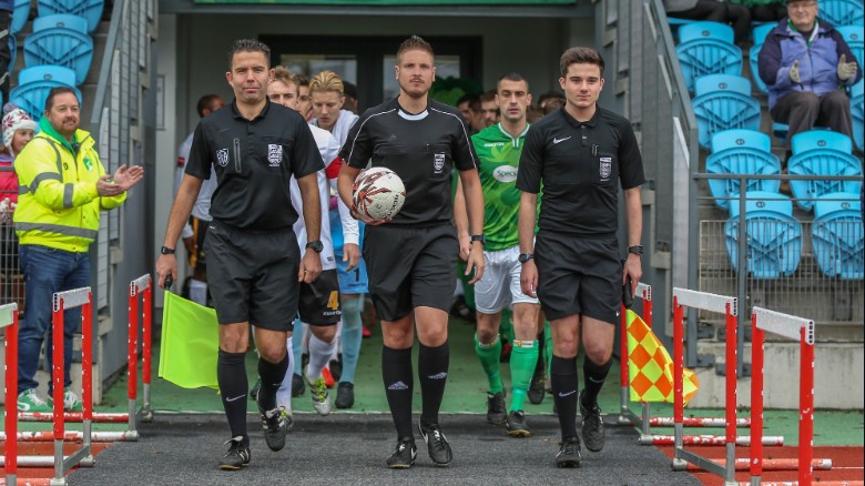 Atkin (center) will work as a fourth official in Football League games this season.