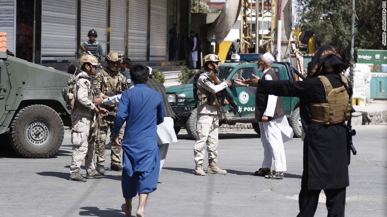 Afghan security officials take positions Friday near the Kabul mosque after the attack.