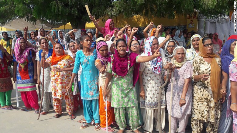 The guru&#39;s supporters gather on the roadside in Sirsa on Thursday before the verdict in the rape case. 
