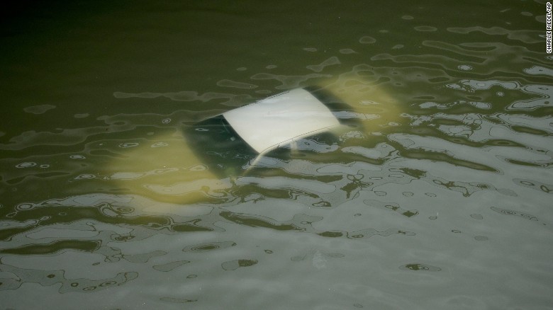 A car is submerged by floodwaters on a freeway near downtown Houston on August 27.