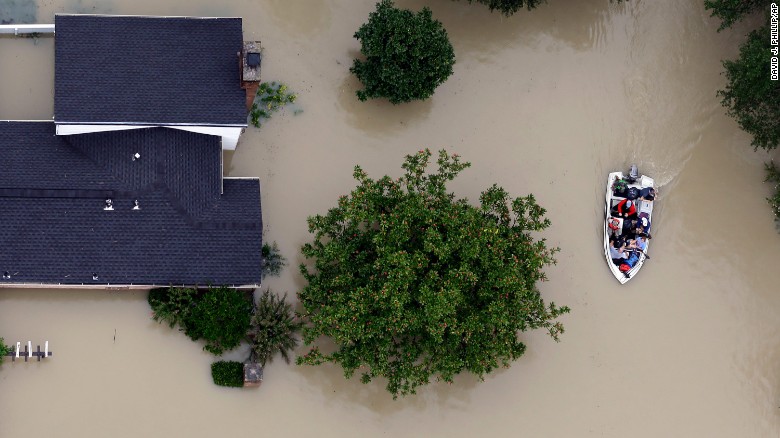 Residents evacuate their homes near Houston&#39;s  Addicks Reservoir on Tuesday.