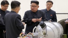 This undated picture released by North Korea&#39;s official Korean Central News Agency (KCNA) on September 3, 2017 shows North Korean leader Kim Jong Un, center, looking at a metal casing with two bulges at an undisclosed location. 