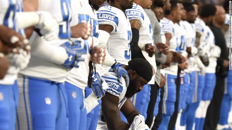 Steve Longa, a linebacker with the Detroit Lions, takes a knee with teammate Jalen Reeves-Maybin during the National Anthem before playing the Minnesota Vikings in Minneapolis, Minnesota. 