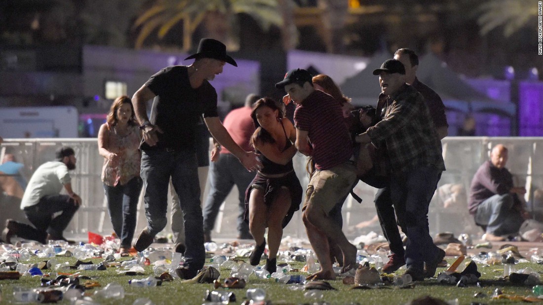 Concertgoers help an injured person after shots were fired at the Route 91 Harvest country music festival on the Las Vegas Strip on Sunday, October 1.