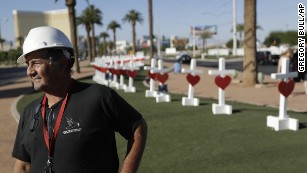 Greg Zanis stands in front of crosses he placed near the city&#39;s famous sign Thursday, Oct. 5, 2017, in Las Vegas. The crosses are in honor of those killed when Stephen Craig Paddock broke windows on the Mandalay Bay resort and casino and began firing with a cache of weapons onto a country music festival Sunday. Dozens of people were killed and hundreds were injured. (AP Photo/Gregory Bull)