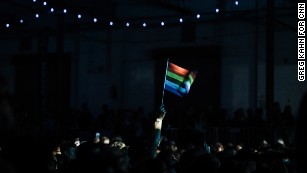A fan waves a rainbow flag during Betty Who&#39;s performance at the &quot;All Things Go Fall Classic&quot; music festival at Union Market in Washington, DC on Oct. 8, 2017